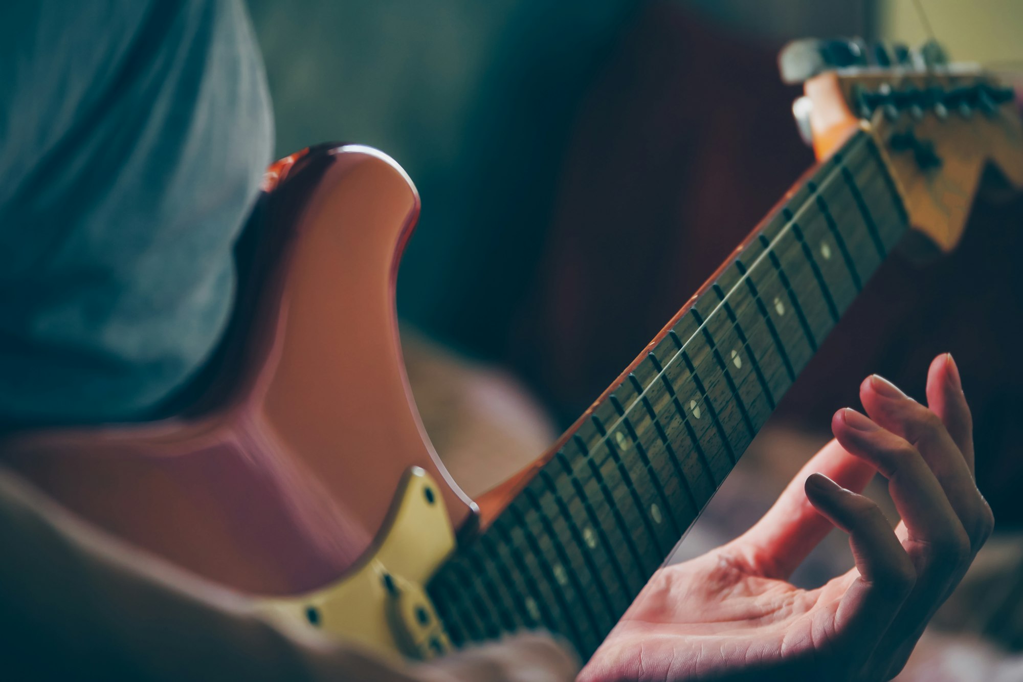 Close up of male hands playing electric guitar. Selective focus