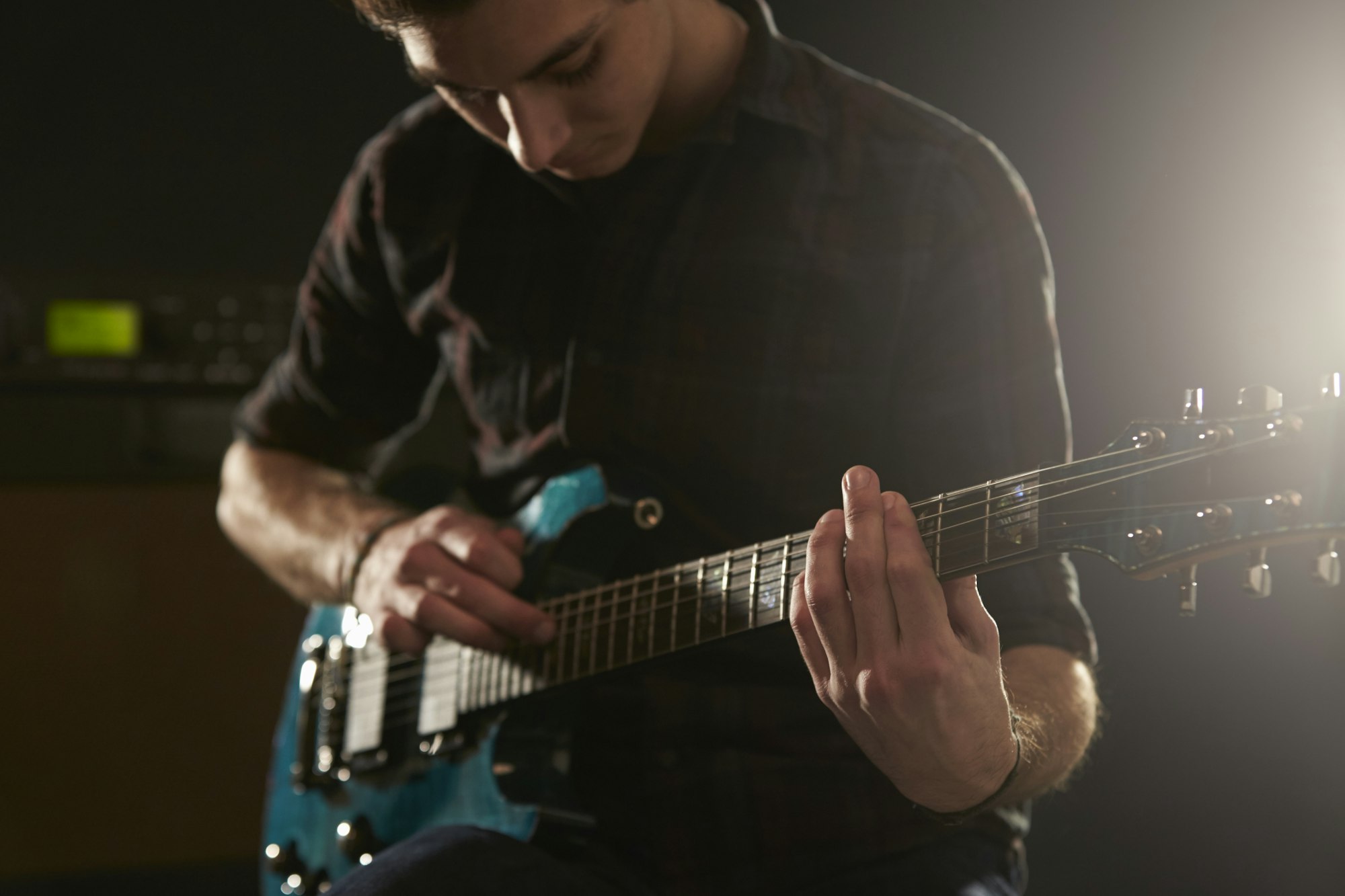 Close Up Of Man Using Tapping Technique On Electric Guitar