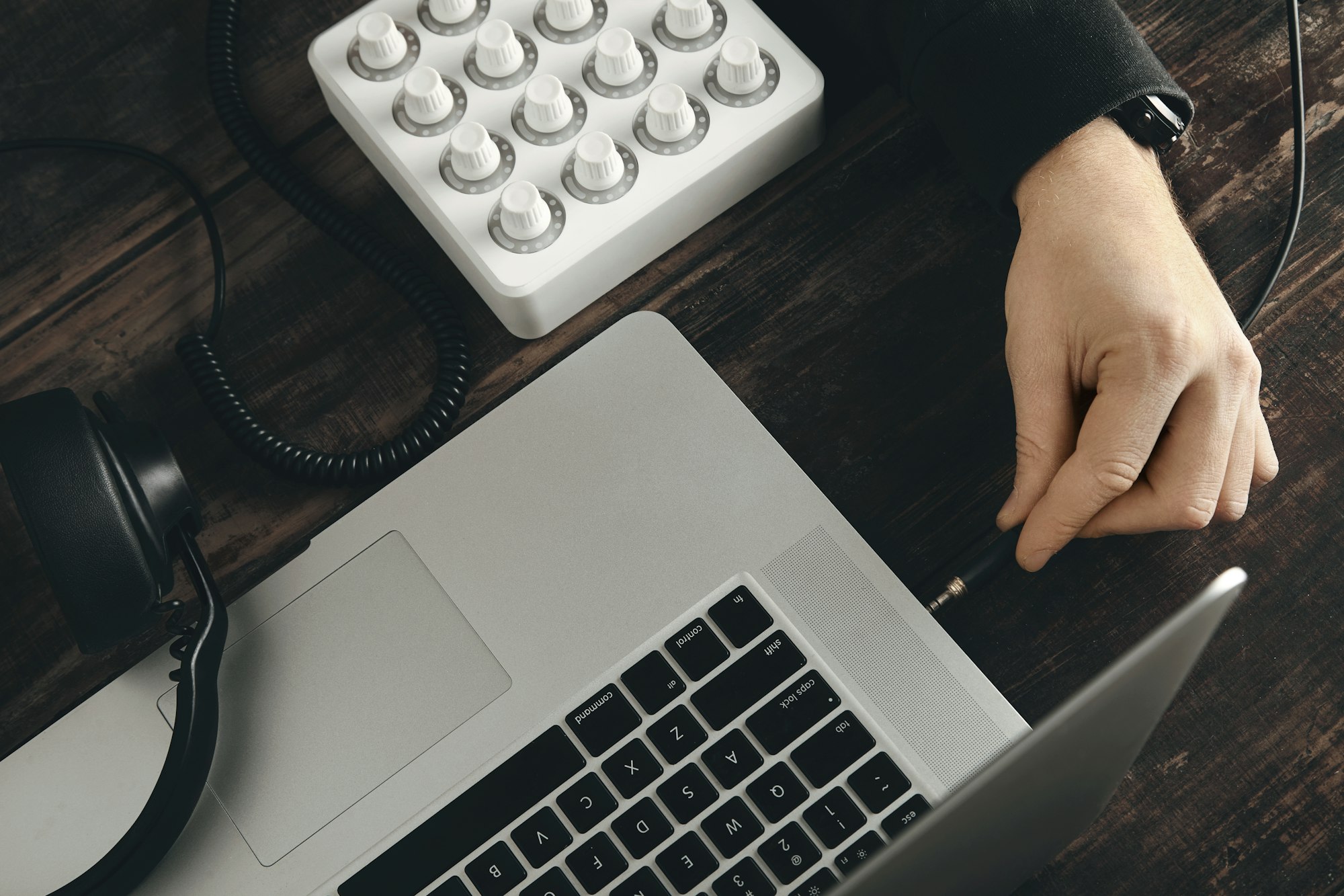 Closeup hand connect headphones to laptop music port