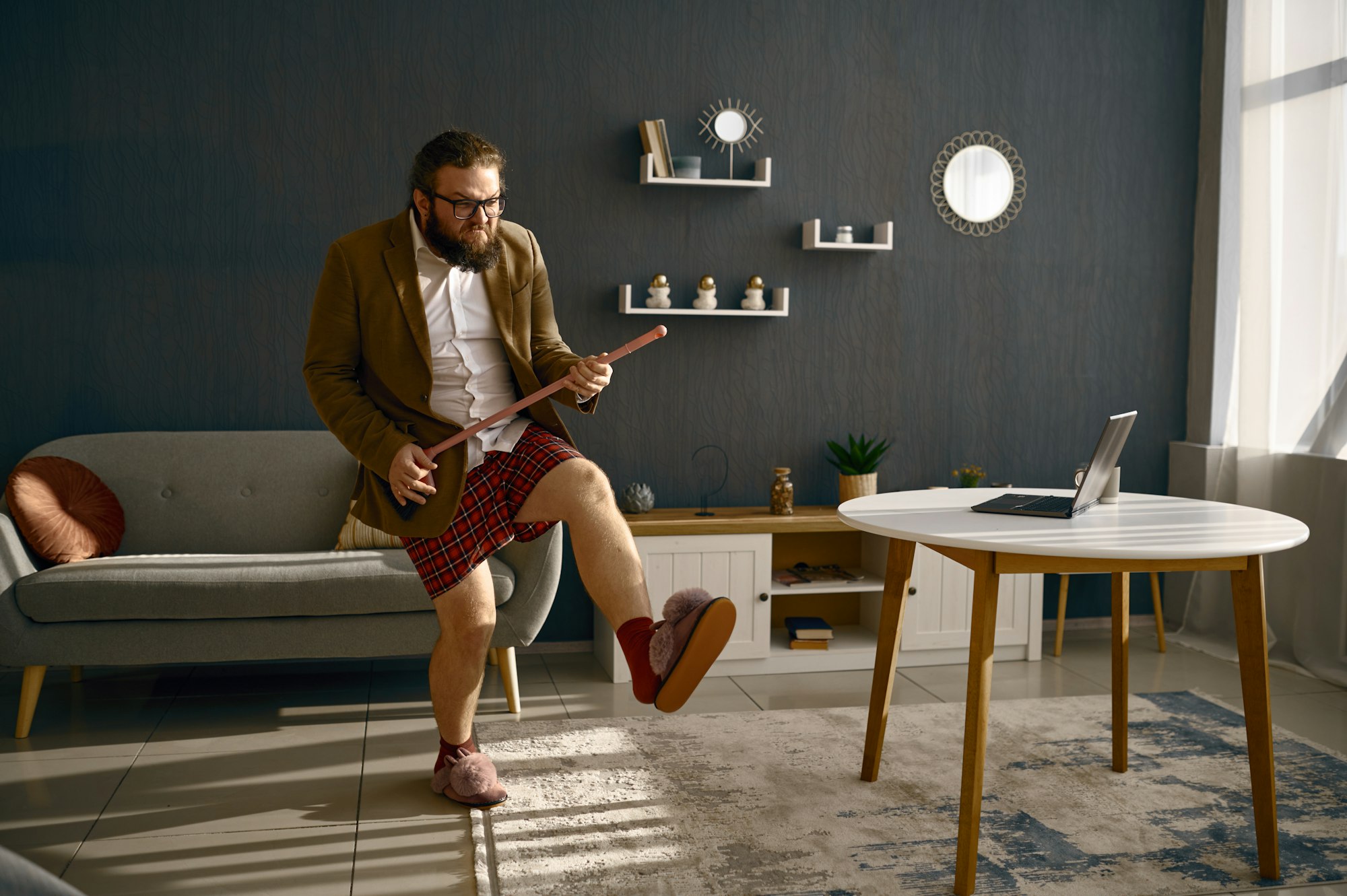 Funny freelance businessman playing broom like guitar