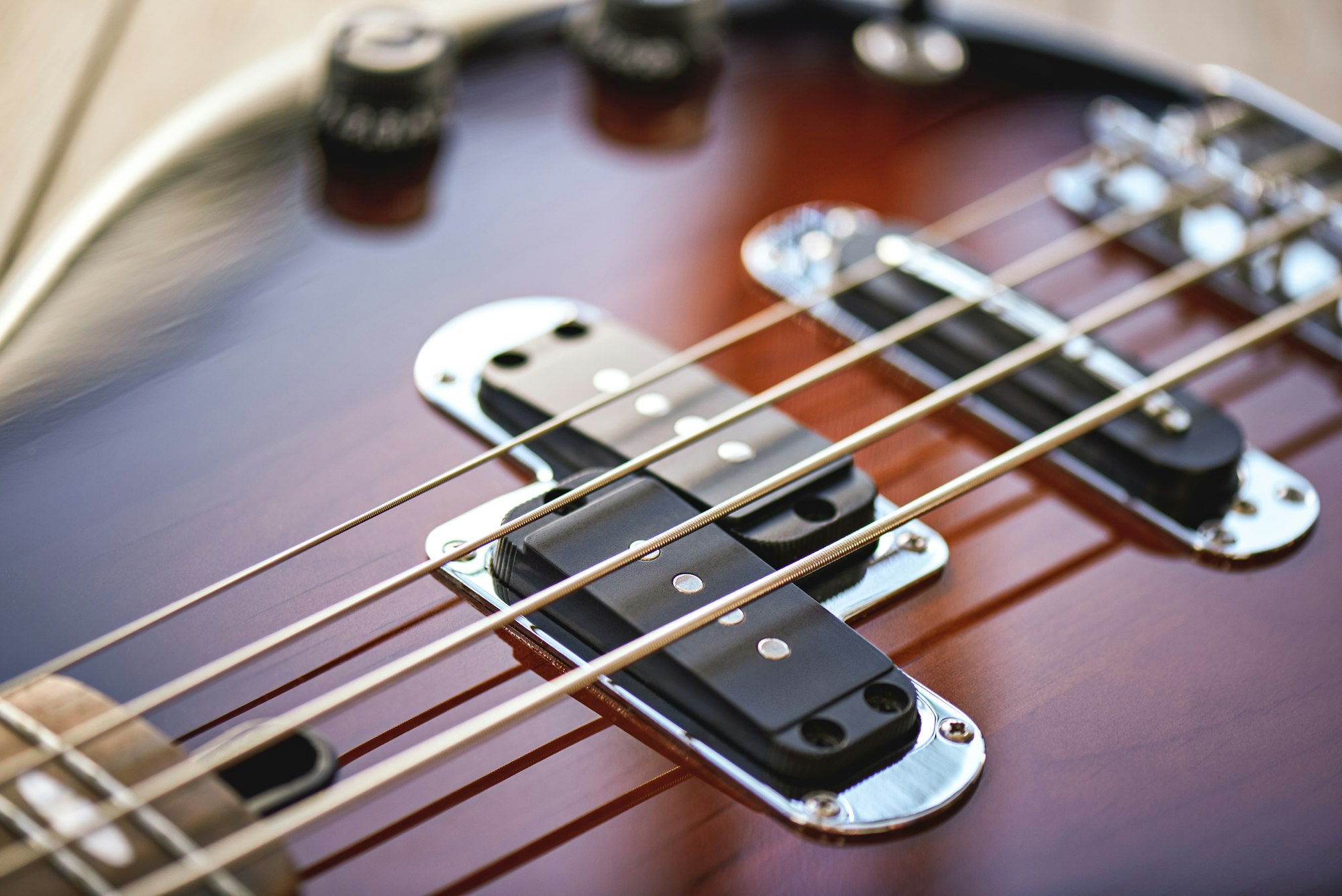 Guitar Lessons. Close-up view of electric guitar body with metal strings, volume and tone controls