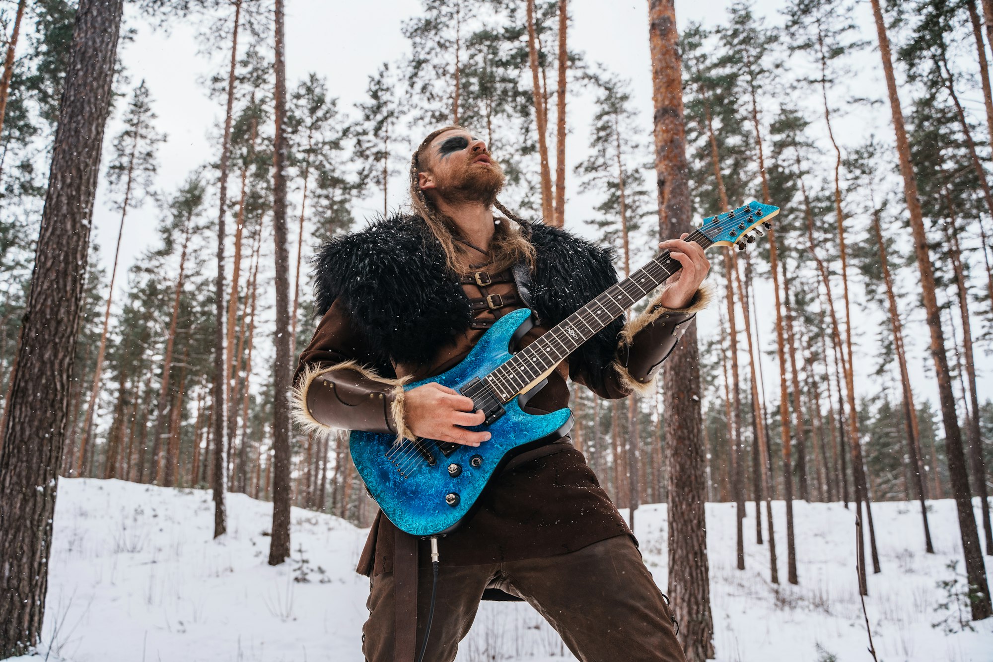 Viking Guitarist in Winter Forest