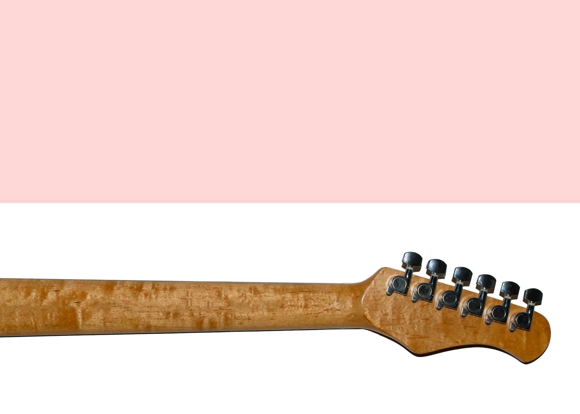 Wooden guitar fretboard isolated on white background. Light pink background for copy space. Flat lay